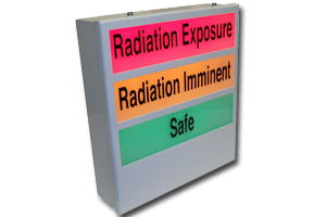 3/4 view of an NDT safety system annunciator with 3 sections. Red section saying Radiation exposure, Orange section saying Radiation Imminent and a green section saying Safe